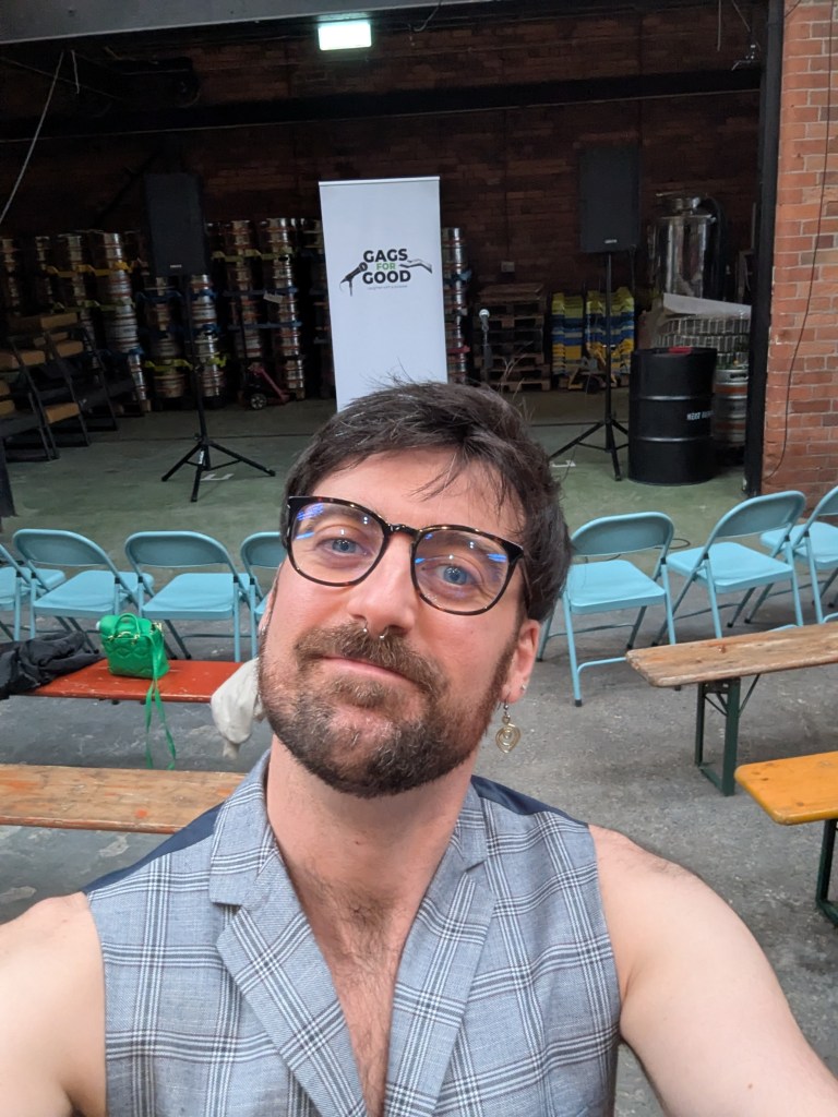 Charlie in front of a empty chairs before a gig